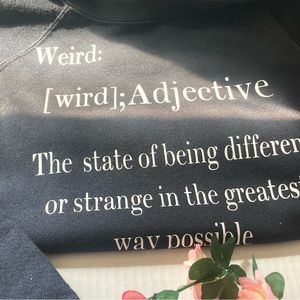 “Weird” sweatshirt designed to look backward